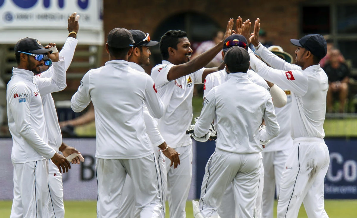 Sri Lanka's bowler Oshada Fernando, centre, celebrates with teammates after taking a wicket during day two of the second cricket test match between South Africa and Sri Lanka at St. George's Park in Port Elizabeth, South Africa, Friday Feb. 22, 2019. (AP Photo/Michael Sheehan)