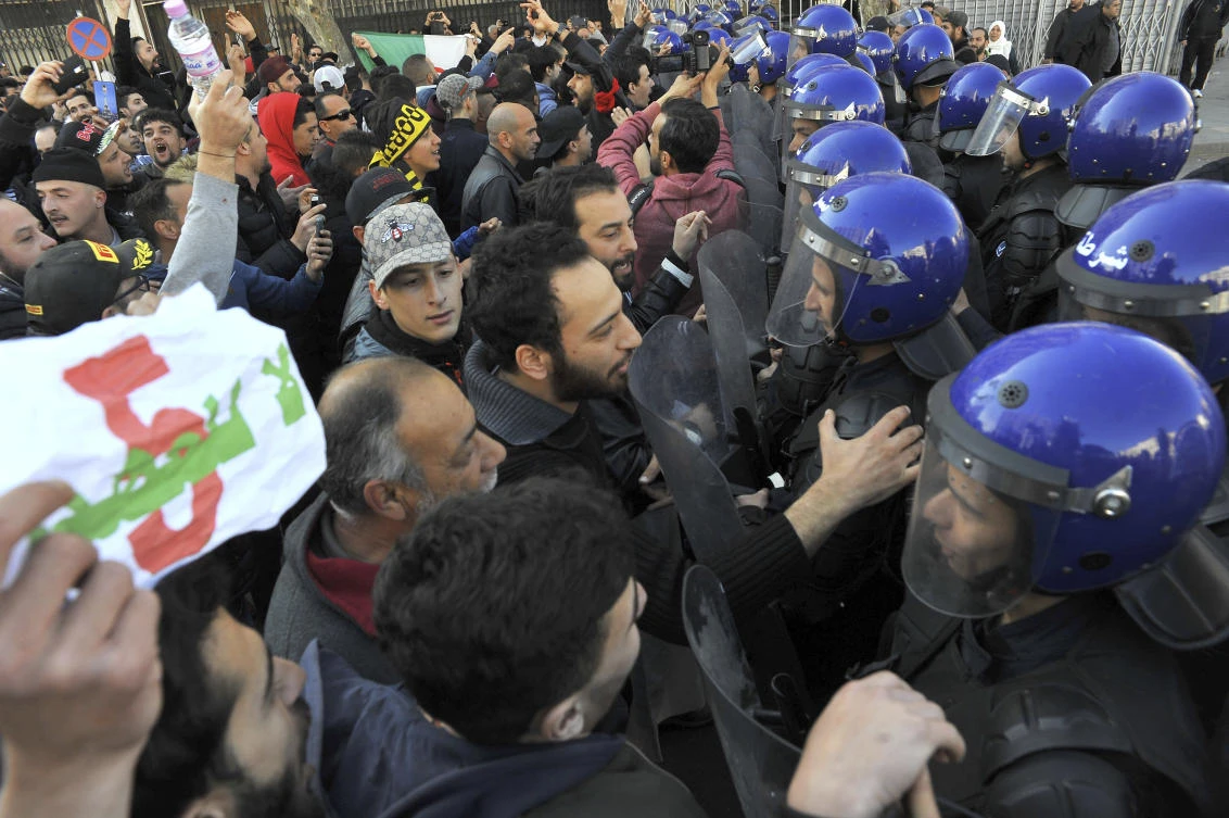 Riot police hold back demonstrators during a demonstration to denounce President Abdelaziz Bouteflika's bid for a fifth term, in Algiers, Algeria, Friday, Feb. 23, 2019. (AP)