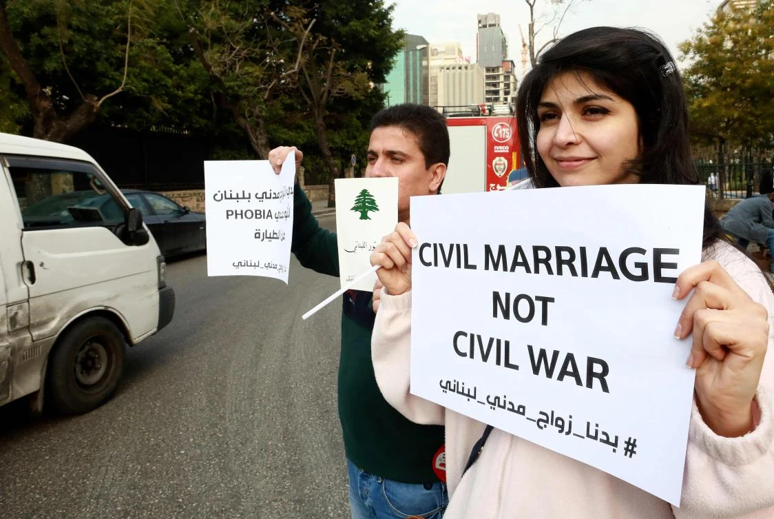 Lebanese demonstrators carry placards during a gathering against the ongoing ban on civil unions outside the Ministry of Interior in the capital Beirut on February 23, 2019. (AFP)