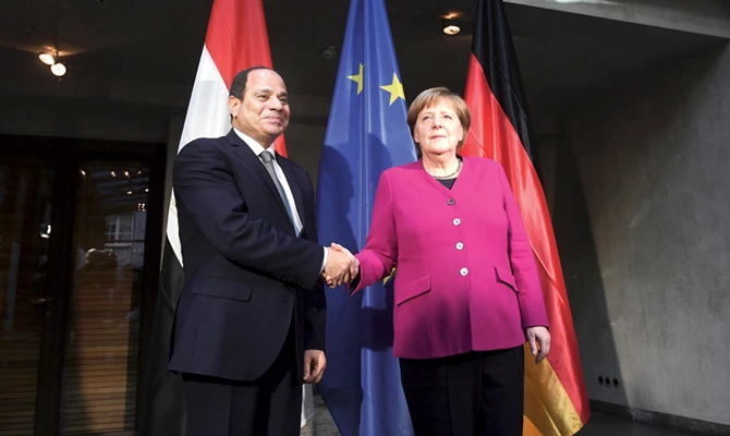 German Chancellor Angela Merkel joins Egyptian President Abdel Fatah El-Sisi in holding the Arab-EU Summit in Egypt on Sunday. (AFP)