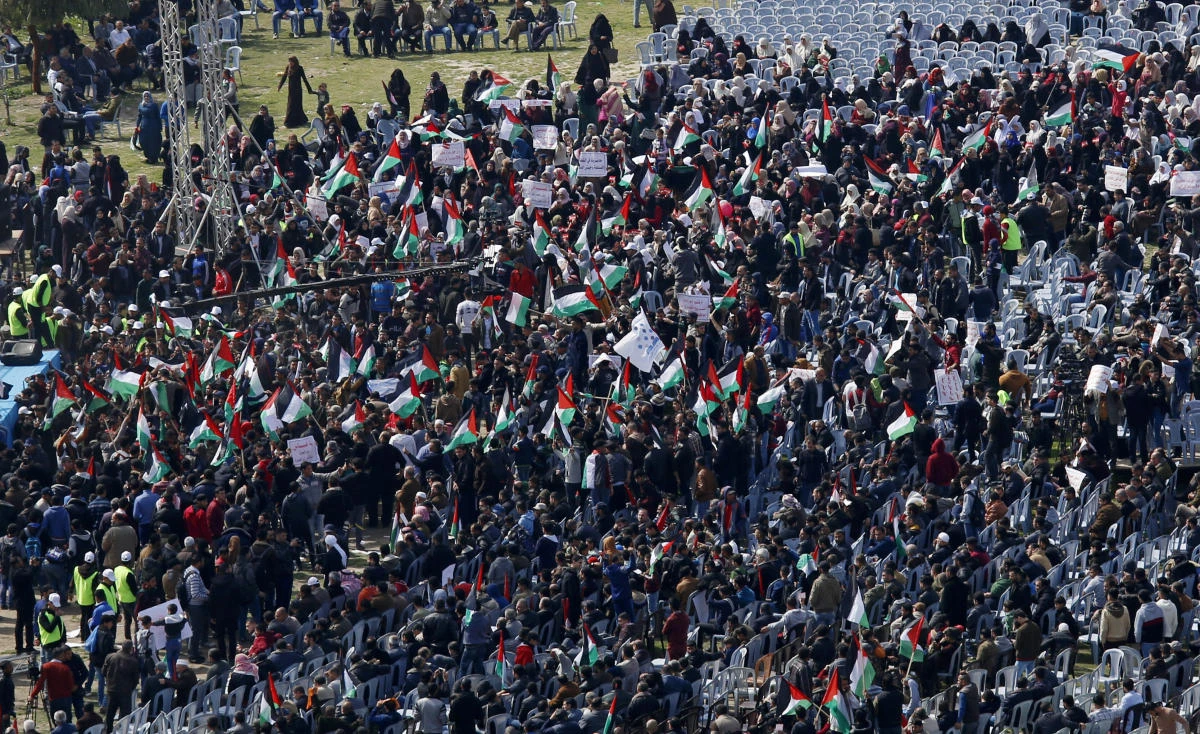 Palestinians wave their national flags during a protest backed by the Gaza territory's Hamas rulers demanding Palestinian President Mahmoud Abbas, of the rival Fatah party, step down, at the main square in Gaza City, Sunday, Feb. 24, 2019. (AP)