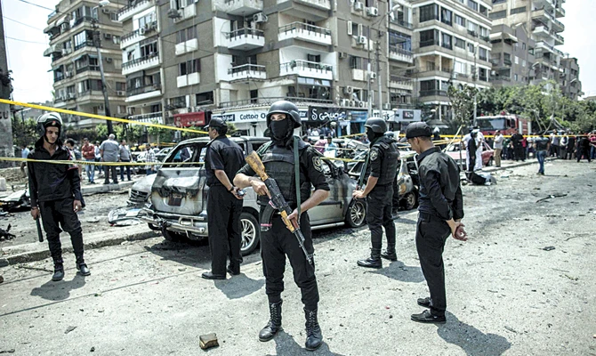 Egyptian policemen stand guard at the site of a bombing in 2015 that killed Egypt's top prosecutor, Hisham Barakat, who oversaw cases against thousands of Islamists, in Cairo. (AP)