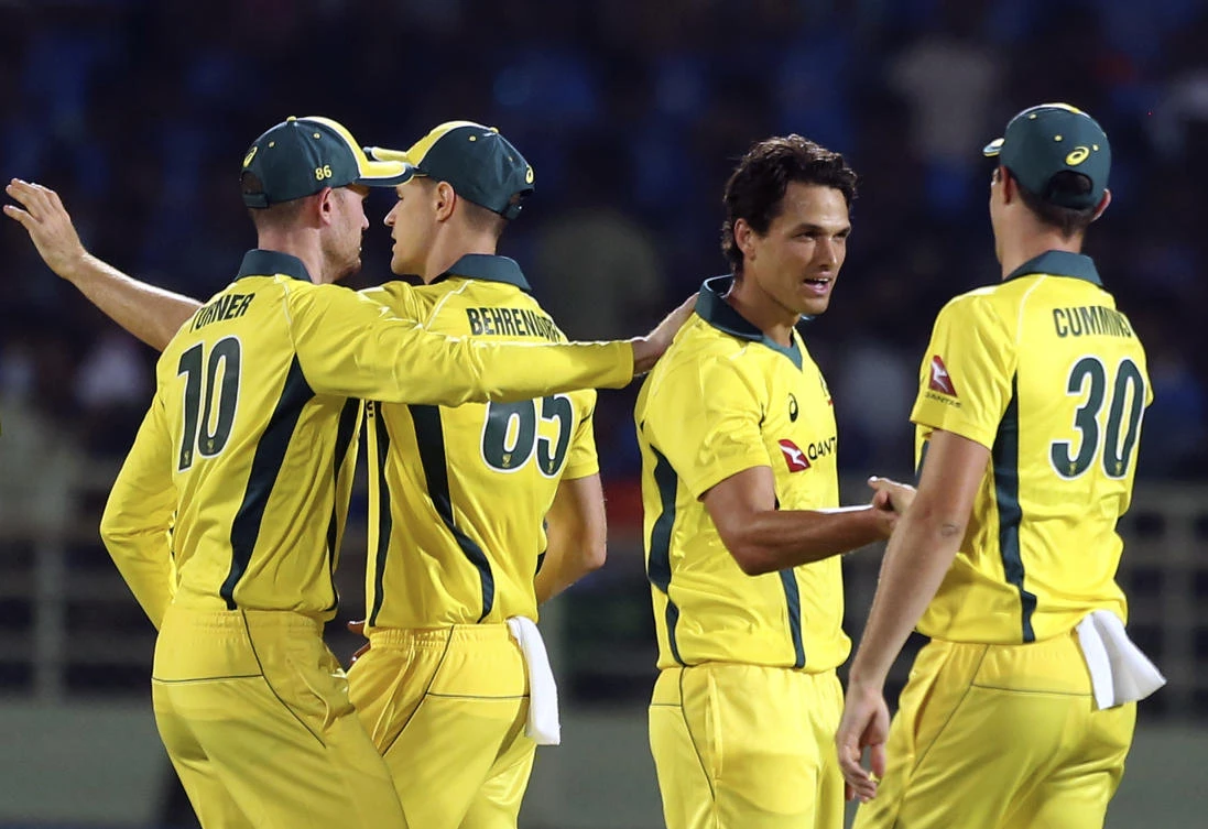 Australia's bowler Nathan Coulter-Nile, second from right, celebrates with Pat Cummins the wicket of India's Krunal Pandya during the first Twenty20 international match between Australia and India. (AP)