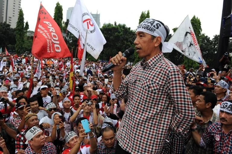 Indonesia has also been battling a wave of fake news and misinformation campaigns online in the lead up to the polls. Above, Joko Widodo on the campaign trail in 2014. (AFP)