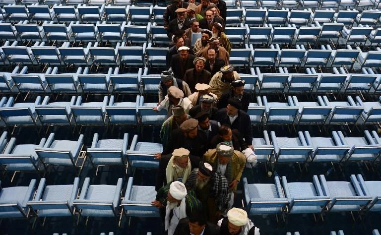 Members of the Afghan loya jirga leave on the last day of the four-day long activity in Kabul on November 24, 2013. A similar gathering is planned on March 17 to discuss how to end the Taliban insurgency. (AFP)