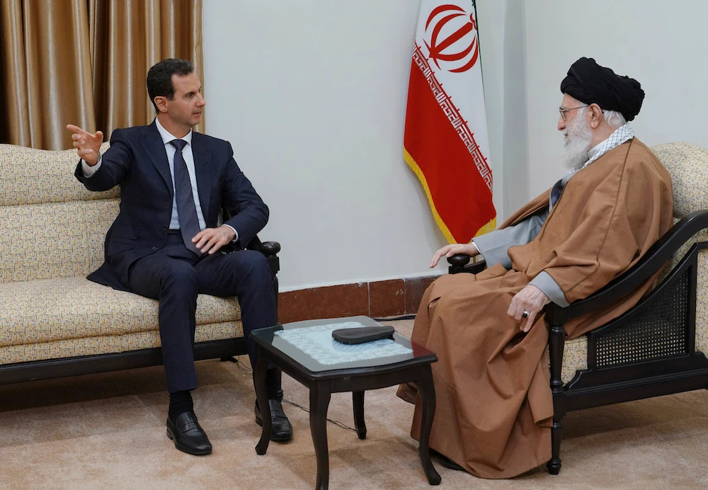 Syrian President Bashar Assad speaks with Iranian Supreme Leader Ayatollah Ali Khamenei, before their meeting in Tehran. (SANA via AP)