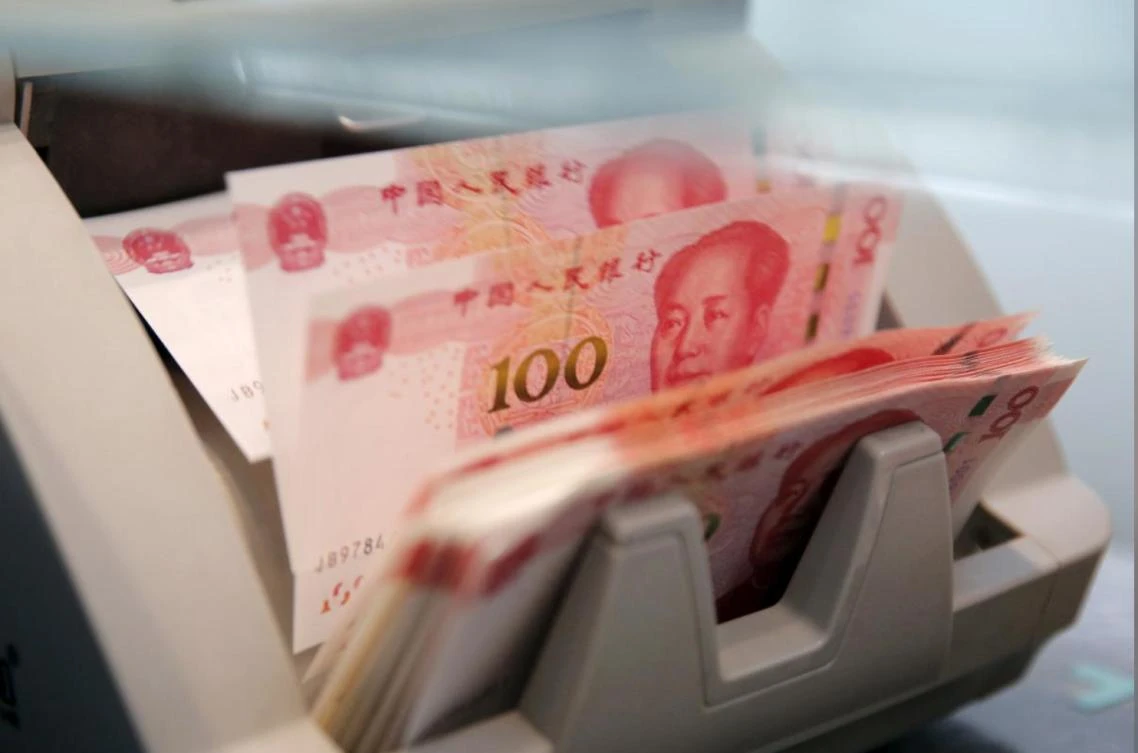 Chinese 100 yuan banknotes are seen in a counting machine while a clerk counts them at a branch of a commercial bank in Beijing, China, in this March 30, 2016 file picture. (Reuters)