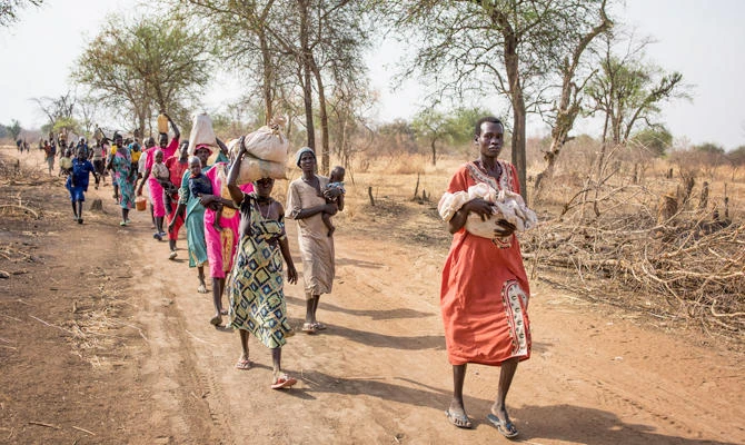 In this Wednesday, April 5, 2017 file photo, people walk to reach a food distribution site in Malualkuel, the Northern Bahr el Ghazal region of South Sudan. (AP)