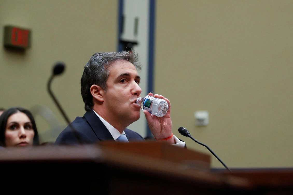 Michael Cohen, the former personal attorney of US President Donald Trump, takes a drink as he testifies before a House Committee on Oversight and Reform hearing on Capitol Hill in Washington, U.S., February 27, 2019. (Reuters)