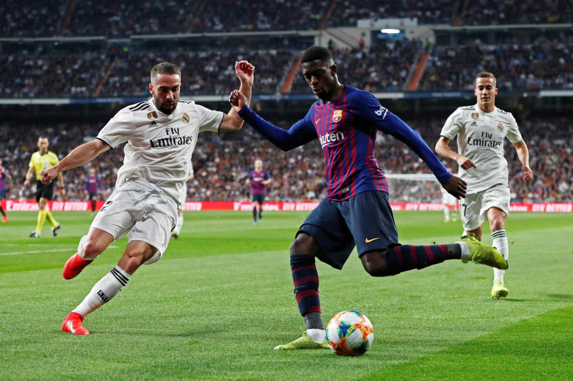 Barcelona's Ousmane Dembele in action with Real Madrid's Dani Carvajal during the clubs' Copa del Rey encounter. (Reuters)