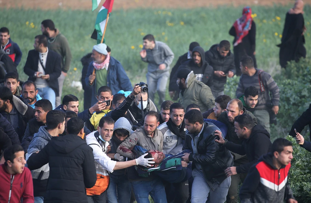 A wounded Palestinian is evacuated during a protest at the Israel-Gaza border fence, in the southern Gaza Strip, on February 22, 2019. (REUTERS/Ibraheem Abu Mustafa/File Photo)