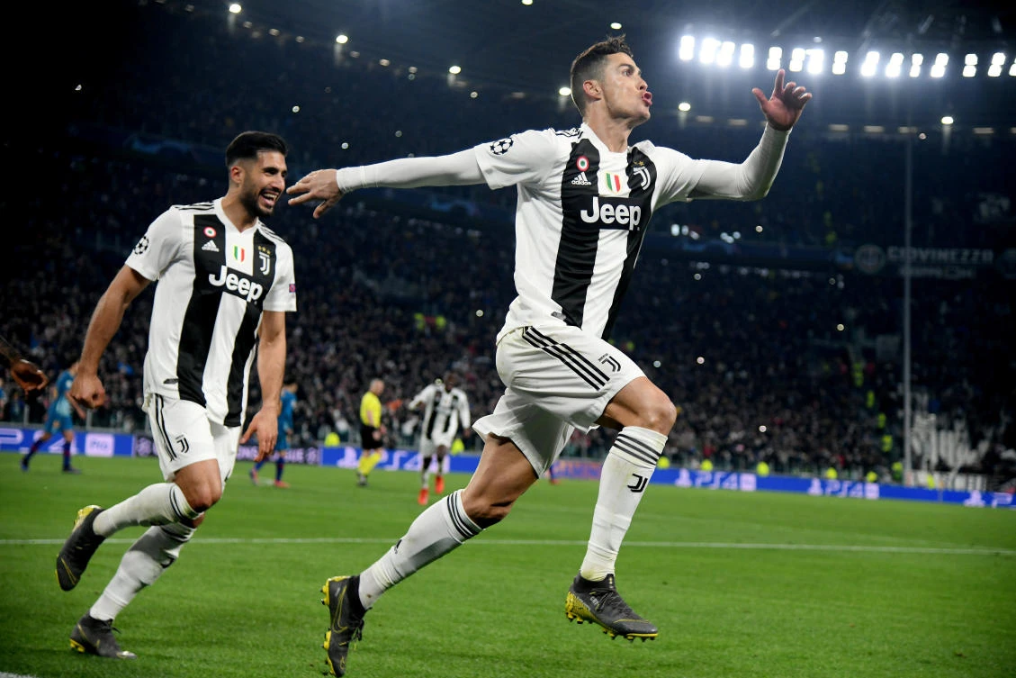 Soccer Football - Champions League - Round of 16 Second Leg - Juventus v Atletico Madrid - Allianz Stadium, Turin, Italy - March 12, 2019 Juventus' Cristiano Ronaldo celebrates scoring their third goal to complete his hat-trick with Emre Can REUTERS/Alberto Lingria TPX IMAGES OF THE DAY