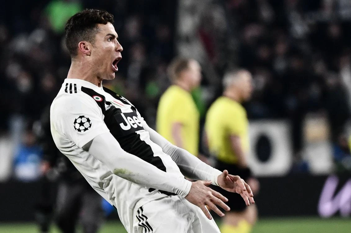 TOPSHOT - Juventus' Portuguese forward Cristiano Ronaldo celebrates after scoring 3-0 during the UEFA Champions League round of 16 second-leg football match Juventus vs Atletico Madrid on March 12, 2019 at the Juventus stadium in Turin. / AFP / Marco BERTORELLO