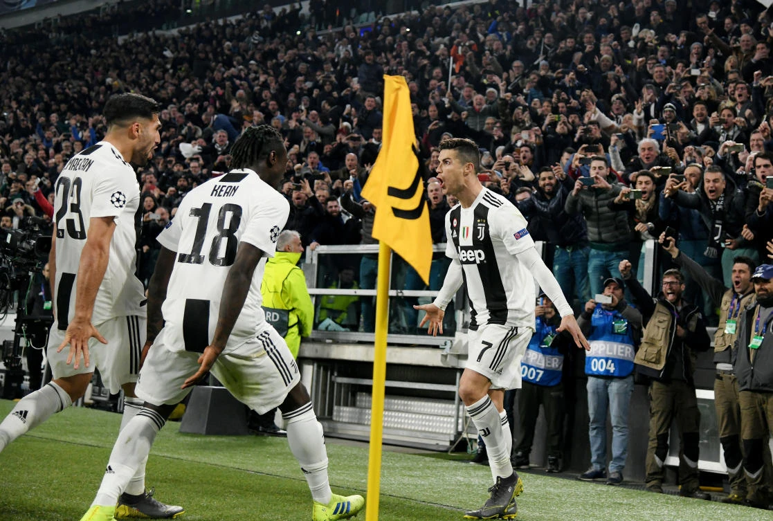 Soccer Football - Champions League - Round of 16 Second Leg - Juventus v Atletico Madrid - Allianz Stadium, Turin, Italy - March 12, 2019 Juventus' Cristiano Ronaldo celebrates scoring their third goal to complete his hat-trick with Emre Can and Moise Kean REUTERS/Alberto Lingria