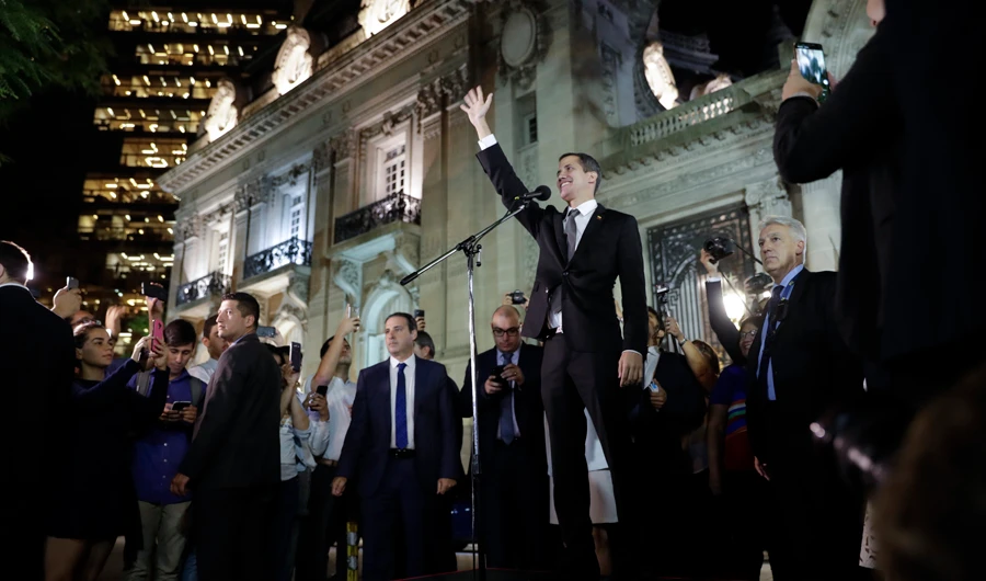 Venezuela's self-proclaimed interim president Juan Guaido waves to supporters outside the Foreign Ministry in Buenos Aires, Argentina. (AP)