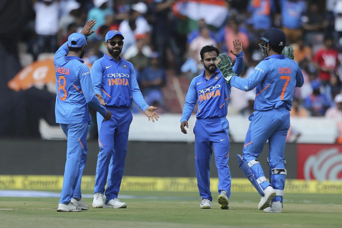 India's bowler Kedar Jadhav celebrates with Mahendra Singh Dhoni the wicket of Australia's Marcus Stoinis during the first one day international cricket match between India and Australia in Hyderabad. (AP)