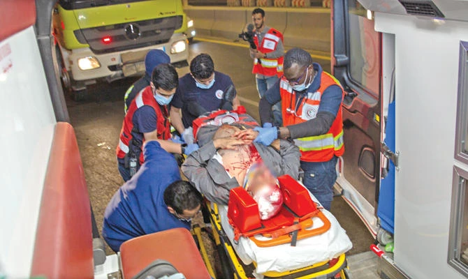 Paramedics carry an injured man into an ambulance. (AN photo)