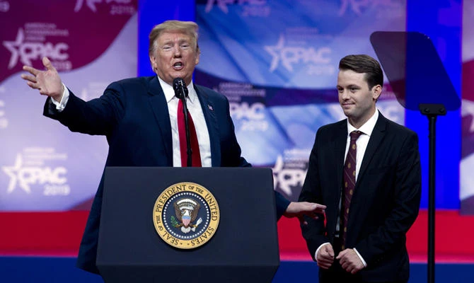 President Donald Trump invites to speak in the podium to Hayden Williams, a field representative of the Leadership Institute, who was assaulted at Berkeley campus, speaks at Conservative Political Action Conference, CPAC 2019, in Oxon Hill, Maryland, on March 2, 2019. (AP Photo/Jose Luis Magana)