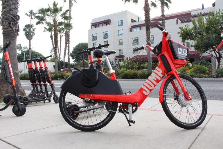 A jump electric bicycle and scooters available to rent by-the-mile through the Uber smartphone application in Santa Monica, California. (AFP)