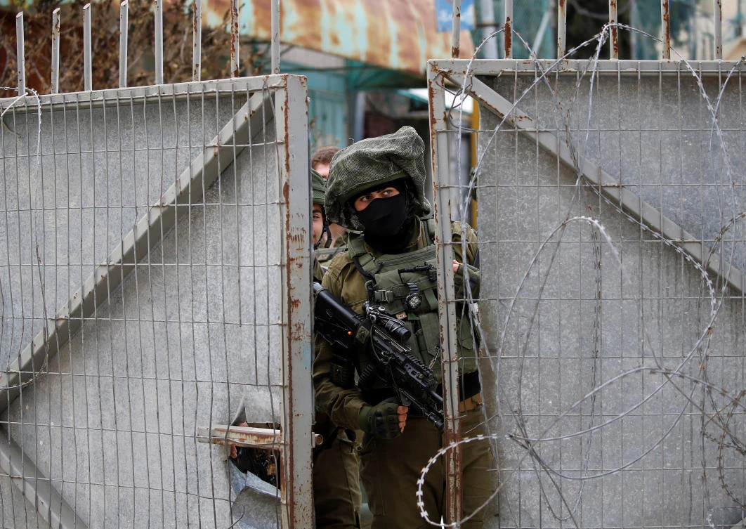 An Israeli soldier looks out during a protest in the Israeli-occupied West Bank February 22, 2019. (Reuters)