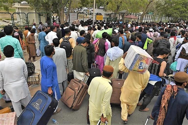 Passengers gather outside the Jinnah International Airport on March 1, 2019 as they wait for flight operations to resume. (AFP)