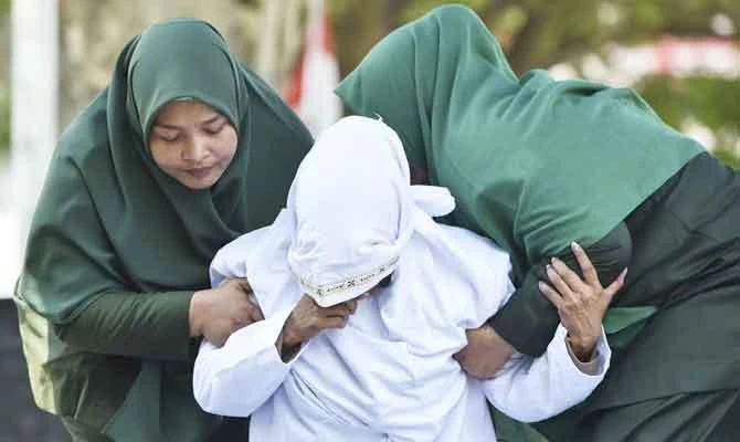 Indonesia’s Aceh whips unmarried couples after hotel raid