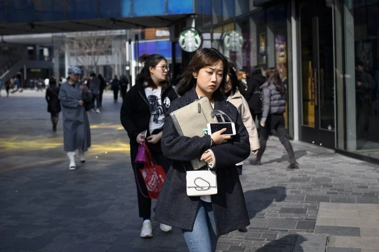China will cut company taxes and employer social insurance contributions paid on behalf of workers by nearly 2 trillion yuan. (AFP)