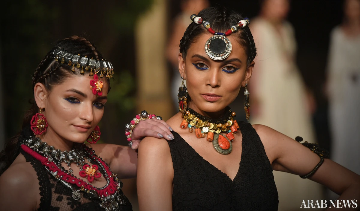 Fashion models, wearing jewelry made by Afghan women refugees, are walking on the ramp in Karachi on Monday. (AN photo)