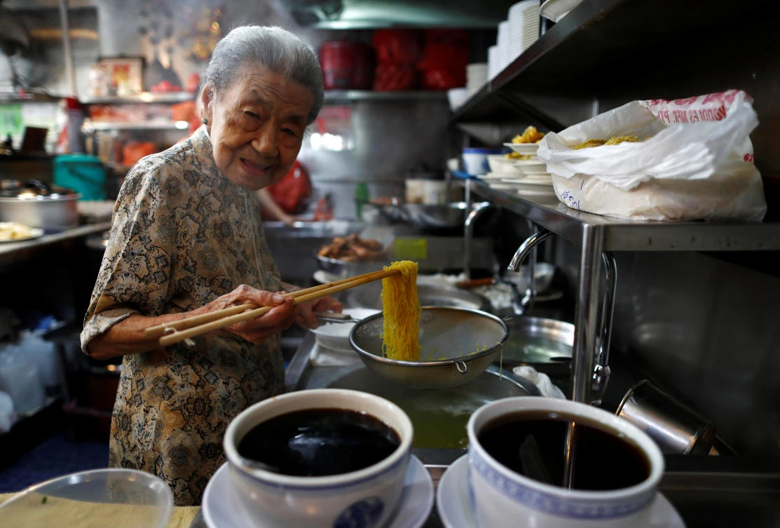 Hawker Leong Yuet Meng runs a wanton noodle stall in downtown Singapore, selling at least 200 bowls on any given day. (Reuters)