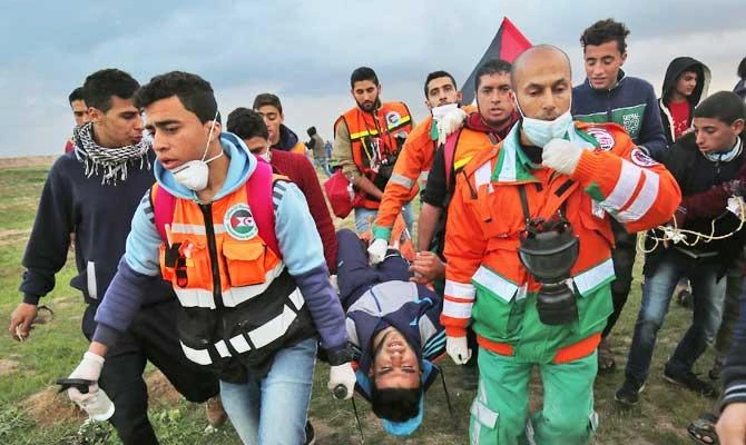 Palestinian paramedics carry away on a stretcher an youth injured during clashes following a demonstration along the border with Israel east of Gaza City on March 1, 2019. (AFP)