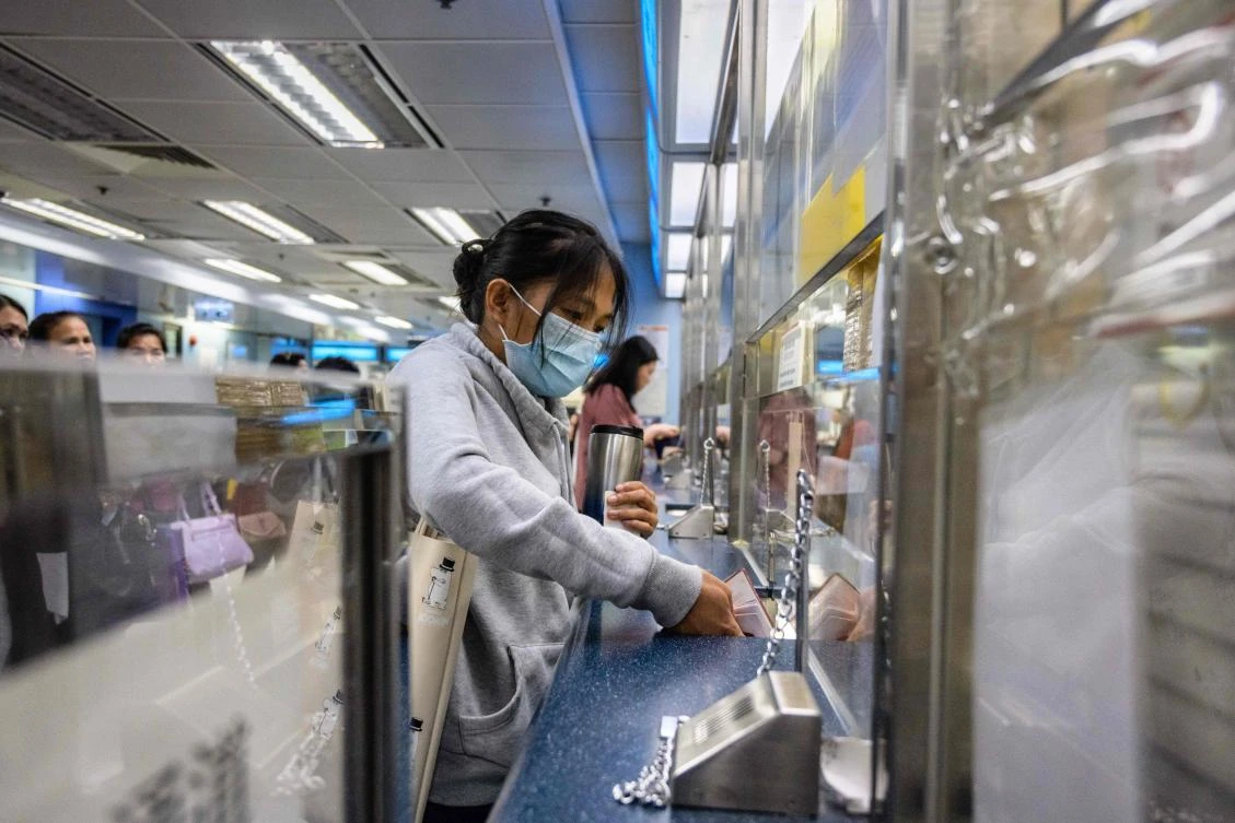Filipina domestic worker Baby Jane Allas applies for a visa extension at the Immigration Office in Hong Kong. (AFP)