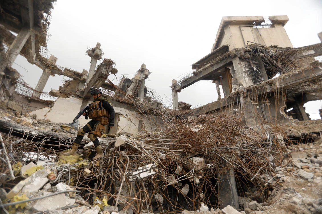 A member of Iraqi security forces walks through the rubble of destroyed buildings in the Old City of Mosul, Iraq. (Reuters)