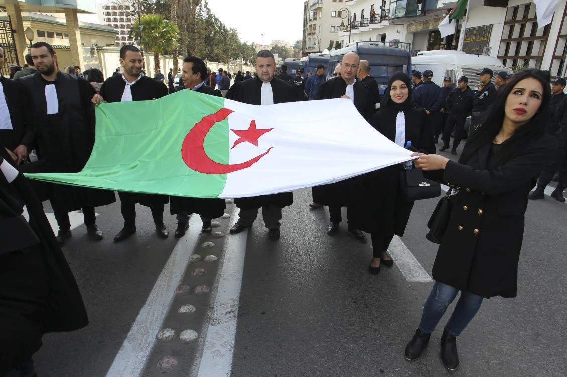 Algerian lawyers carrying their national flag march to the constitutional council in a protest against President Abdelaziz Bouteflika, Thursday March 7, 2019 in Algiers. (AP)