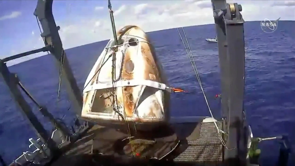 An unmanned capsule of the SpaceX Crew Dragon spacecraft is seen as it was lifted out of the ocean and loaded on the recovery ship, after splashing down into the Atlantic Ocean, about 200 miles off the Florida coast, US. (NASA via Reuters)