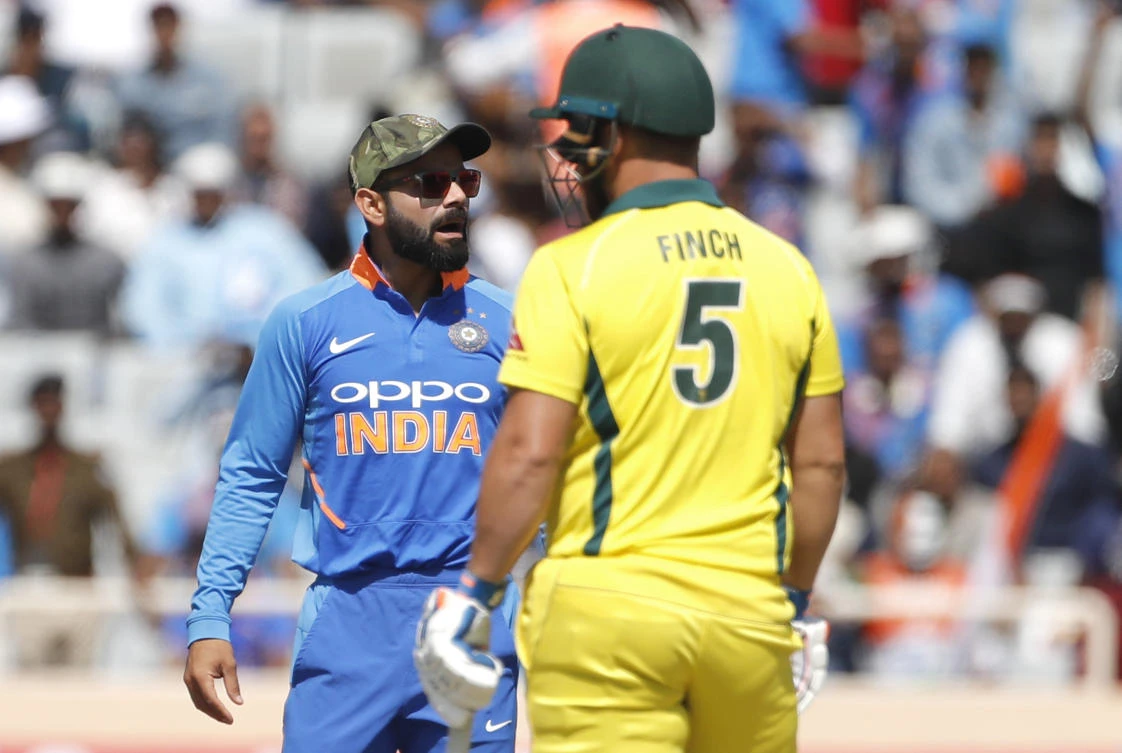 India's captain Virat Kohli, left, interacts with teammates before asking for a review for the wicket of Australia's captain Aaron Finch, right, during the third one day international cricket match between India and Australia in Ranchi, India, Friday, March 8, 2019. (AP Photo/Aijaz Rahi)