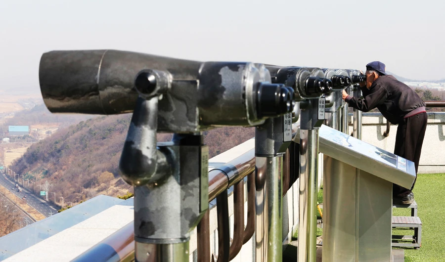 A man watches the North Korean side on Friday at the Unification Observation Post in Paju, South Korea. (AP)
