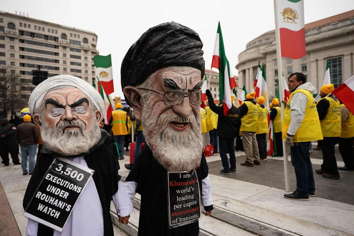 Figures of Iran’s President Hassan Rouhani, left, and Iran’s supreme leader Ayatollah Ali Khamenei, right, marching during the Iranian-American communities’ protests in Washington. (AFP)