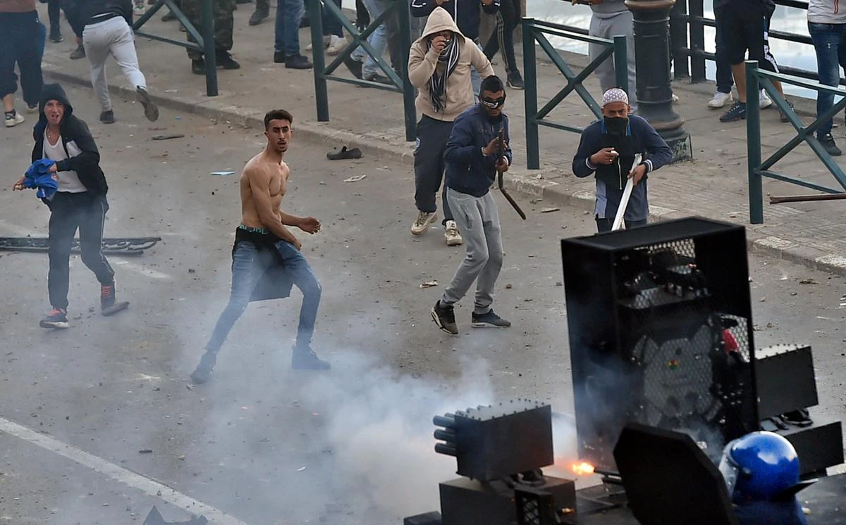 Algerian protesters clash with security forces in the capital Algiers on March 1, 2019, during protests against ailing President Abdelaziz Bouteflika's bid for a fifth term in power. (AFP)