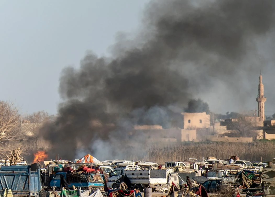 Smokes rises from a makeshift camp for Daesh and their families in Baghouz, the last enclave of the most hardened militants in Syria. (AFP)