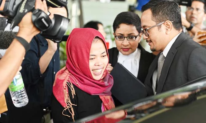 Indonesian national Siti Aisyah (C) smiles while leaving the Shah Alam High Court, outside Kuala Lumpur on March 11, 2019 after her trial for her alleged role in the assassination of Kim Jong Nam, the half-brother of North Korean leader Kim Jong Un. (AFP)
