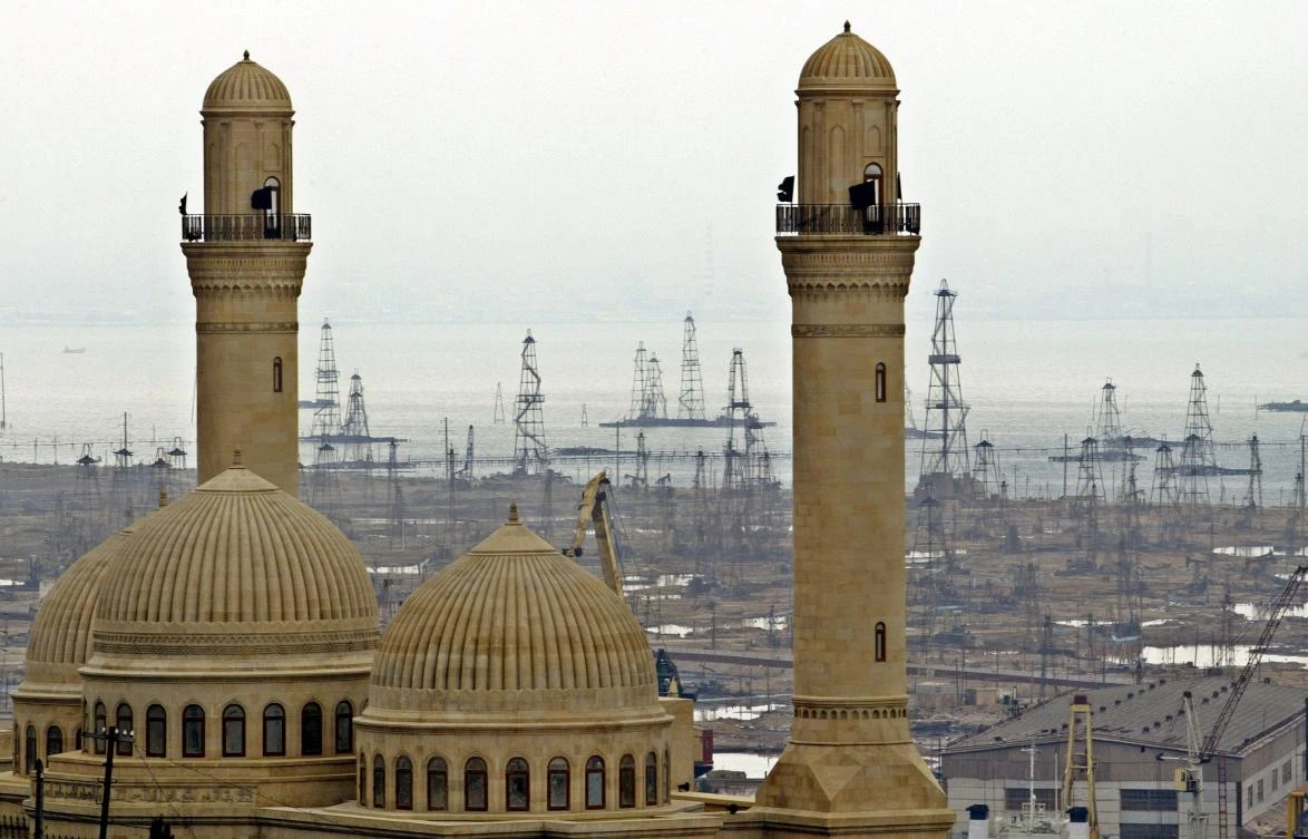 This March 3, 2006 file photo, shows oil derricks in the background beyond the Bibi Heybat Mosque in Baku, Azerbaijan. (AP)