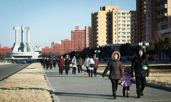 In a photo taken on February 17, 2019 people walk before the Monument to the Party Founding in Pyongyang. Ahead of his second summit with North Korean leader Kim Jong Un, US President Donald Trump has touted the prospect of the impoverished, isolated and nuclear-armed country becoming an "Economic Powerhouse" if it follows a path of peace. (AFP)