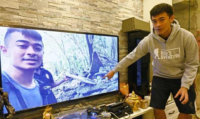 This photo taken on February 13, 2019 shows Taiwanese YouTuber Ben Wu talking about his travels while displaying a video during an interview in Taipei. (AFP)