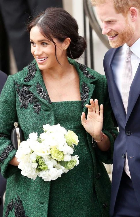 Britain's Prince Harry, Duke of Sussex (R) and Meghan, Duchess of Sussex react as they leave from Canada House, the offices of the High Commission of Canada in the United Kingdom, after attending an event to mark Commonwealth Day, in central London, on March 11, 2019. (AFP)