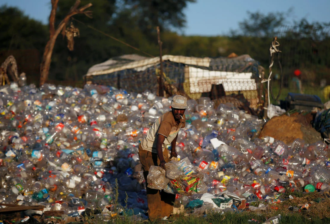A man collects waste materials including plastic bottles to be recycled at an informal settlement in Kliptown, Soweto, South Africa, February 27, 2019. (Reuters/Siphiwe Sibeko)