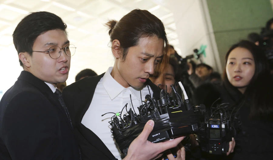 K-pop singer Jung Joon-young, center, arrives at the Seoul Metropolitan Police Agency in Seoul, South Korea, on March 14, 2019. (AP Photo/Ahn Young-joon)