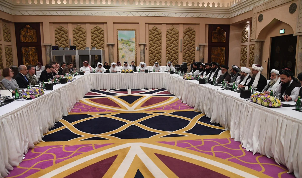 In this handout file photo taken on Feb. 26, 2019, Qatari officials, center, take part in meeting between US special envoy Zalmay Khalilzad, second left, the US delegation, Sher Mohammad Abbas Stanikzai, sixth right, and the Taliban delegation, in Doha. (Qatar’s Ministry of Foreign Affairs via AFP)