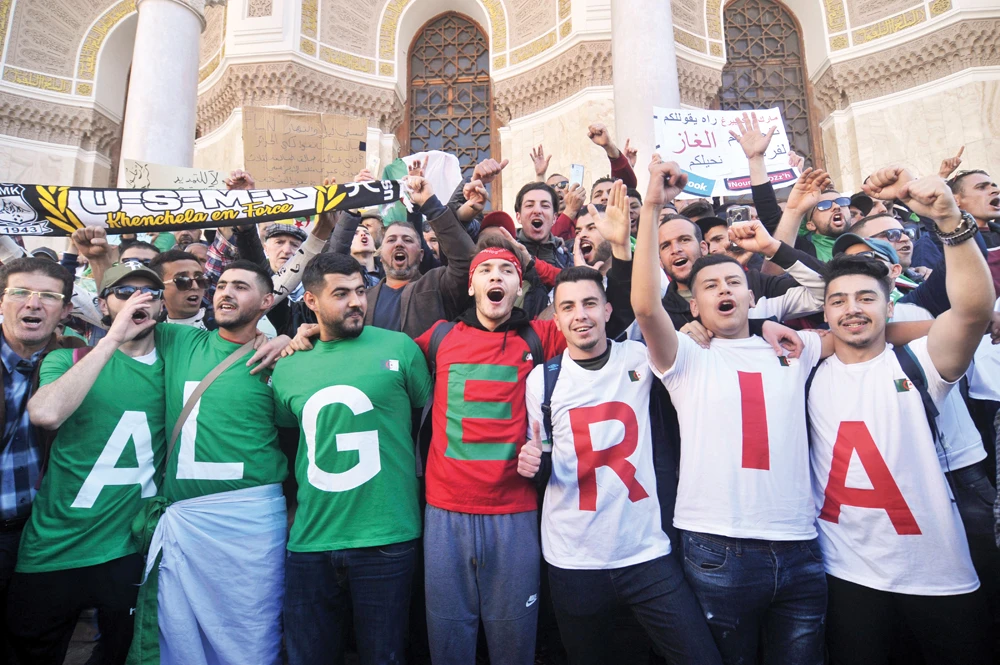 Tens of thousands of people joined protests in Algiers and other cities on Friday. (AP)