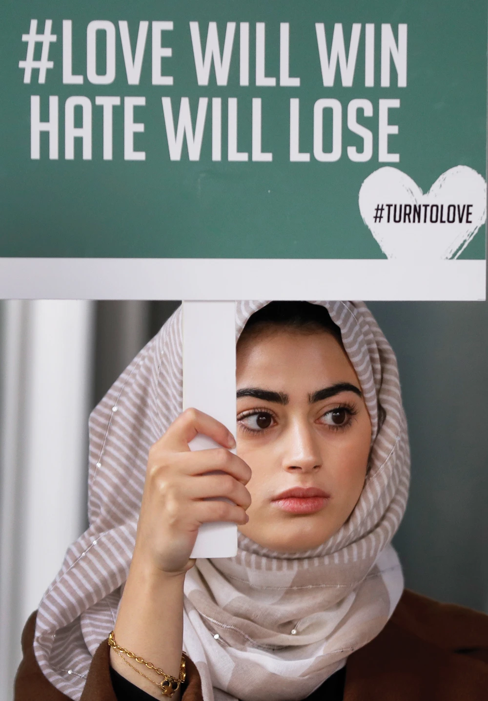 A demonstrator holds a banner during a vigil in London on Friday. (AP)