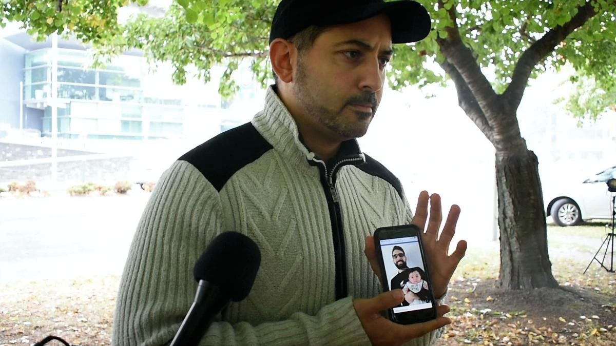 Ghassan Alaraji shows on his mobile phone a photo of his friend Atta Elayyan and his young daughter. Elayyan died during Friday’s terror attack in Christchurch, New Zealand. (AN photo by Steven Walton)